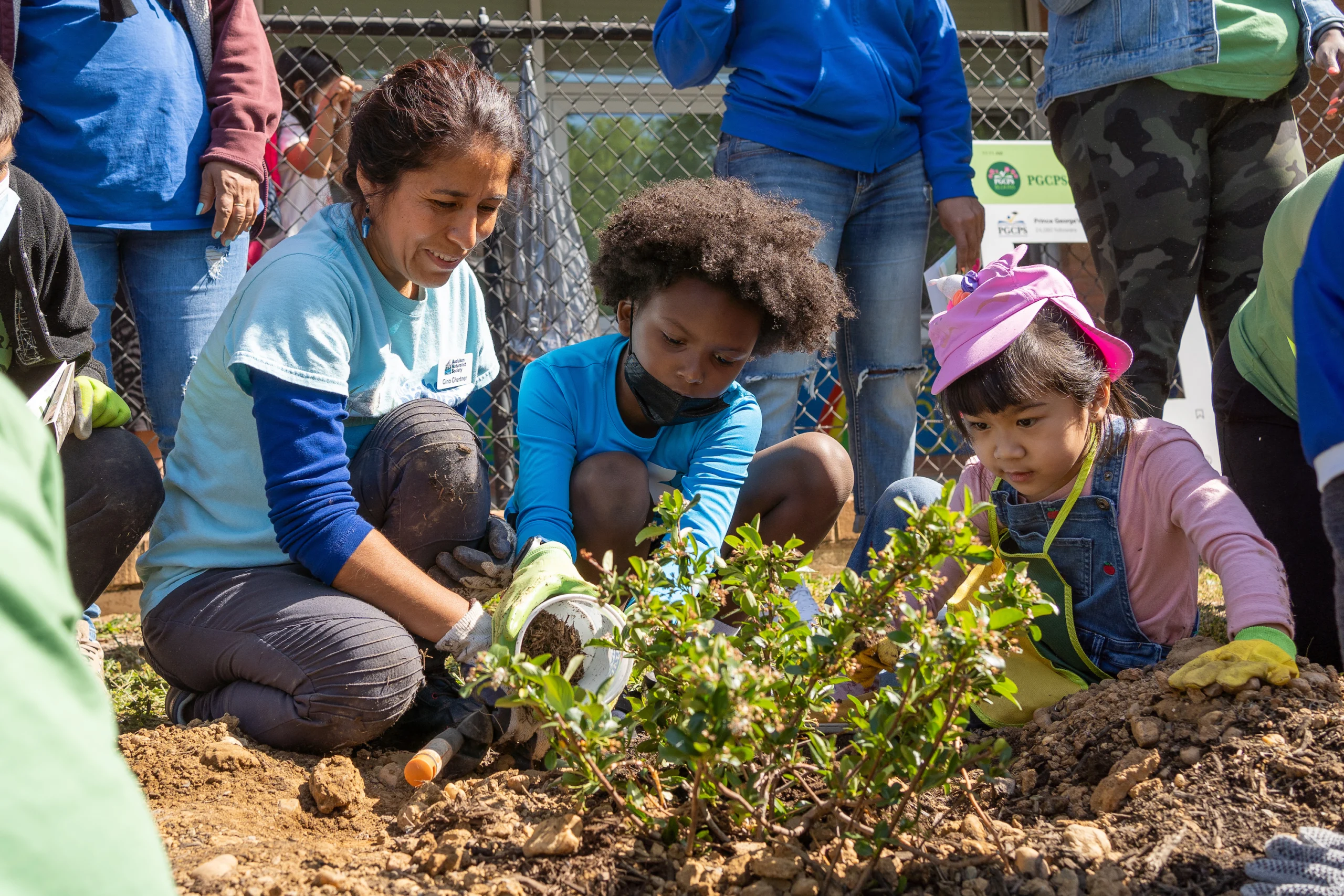Children planting with adult guidance - Riverdale ES Earth Day 2022