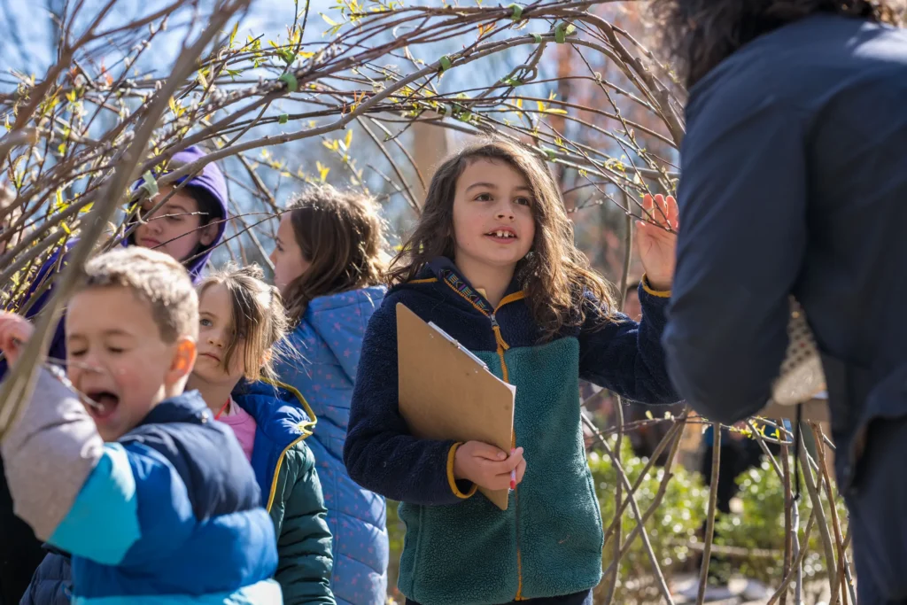 Children explore a sun-dappled garden