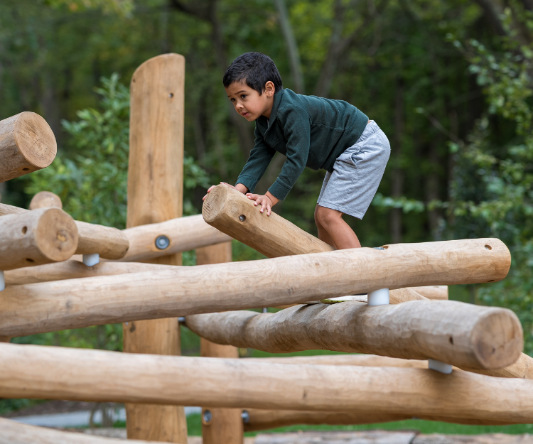 A child playing at the Nature Play Space at Woodend Nature Sanctuary